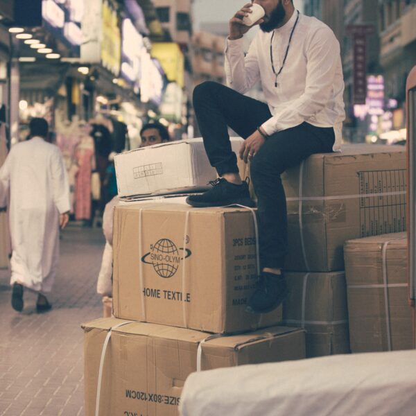 man sitting on boxes outdoors