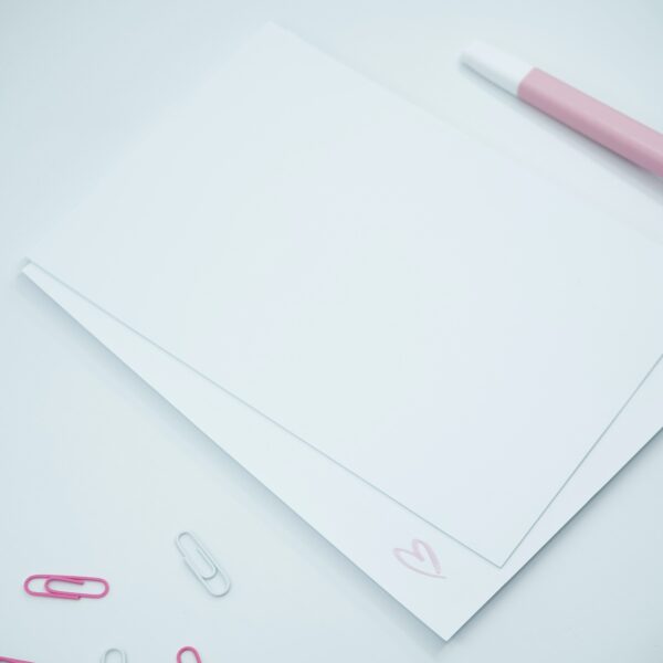 white paper with pink pen